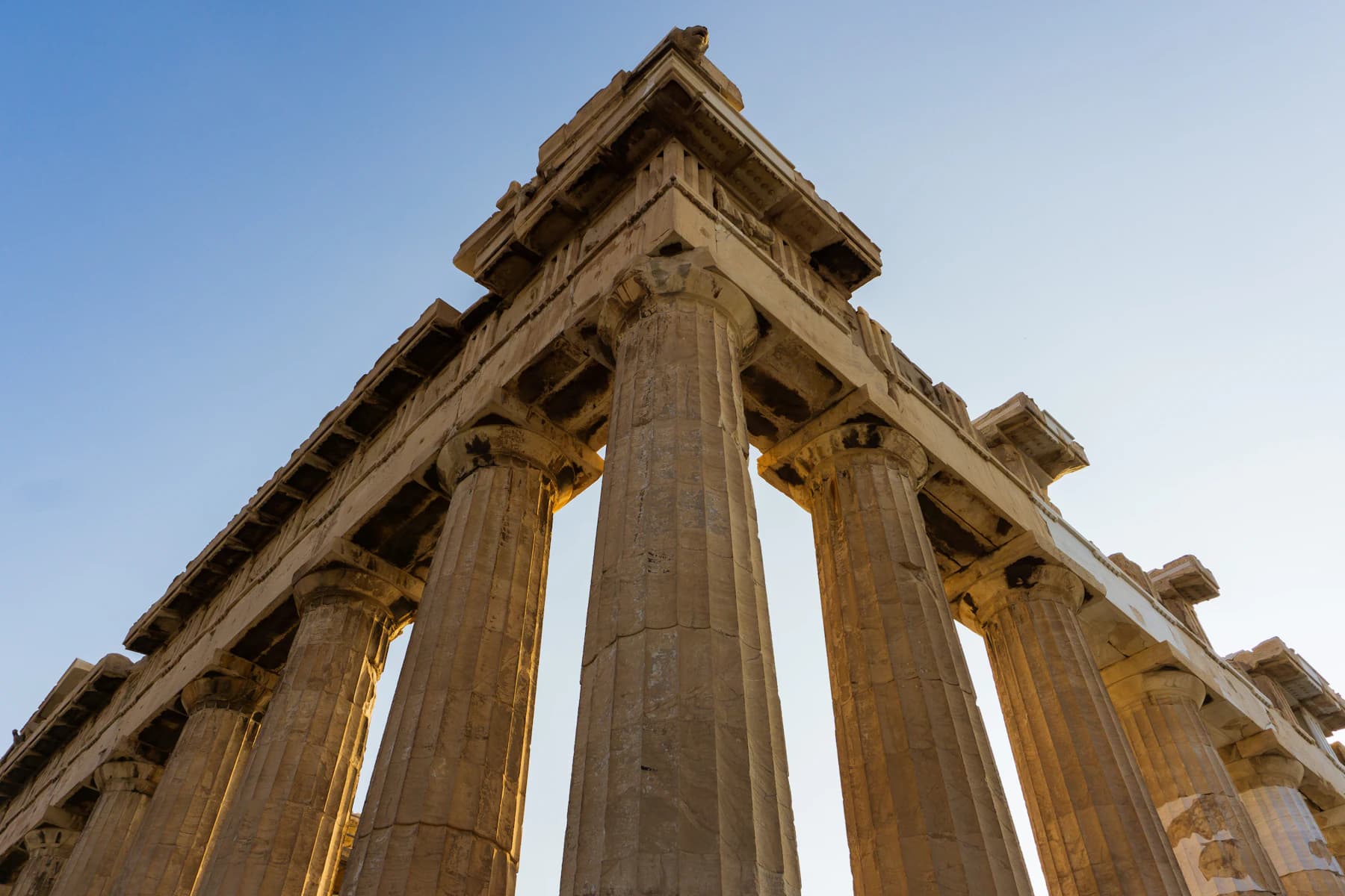 Sunlit columns of the Parthenon viewed from below in Athens